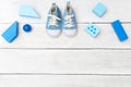 BoyÃ¢â¬â¢s blue shoes and toys on a white wooden background. View from above Royalty Free Stock Photo